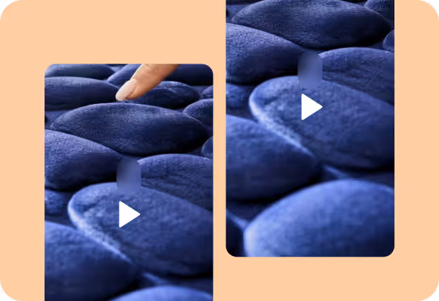 Index finger pressing on a dark blue padded cushion surface with pebble-like shapes.